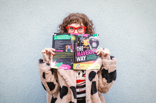 Shari Teigman holding The Maverick Way in front of her face